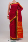 Maroon Kanchipuram Silk Saree with Zari Butta on the body and Zari Border.  displayed on a mannequin