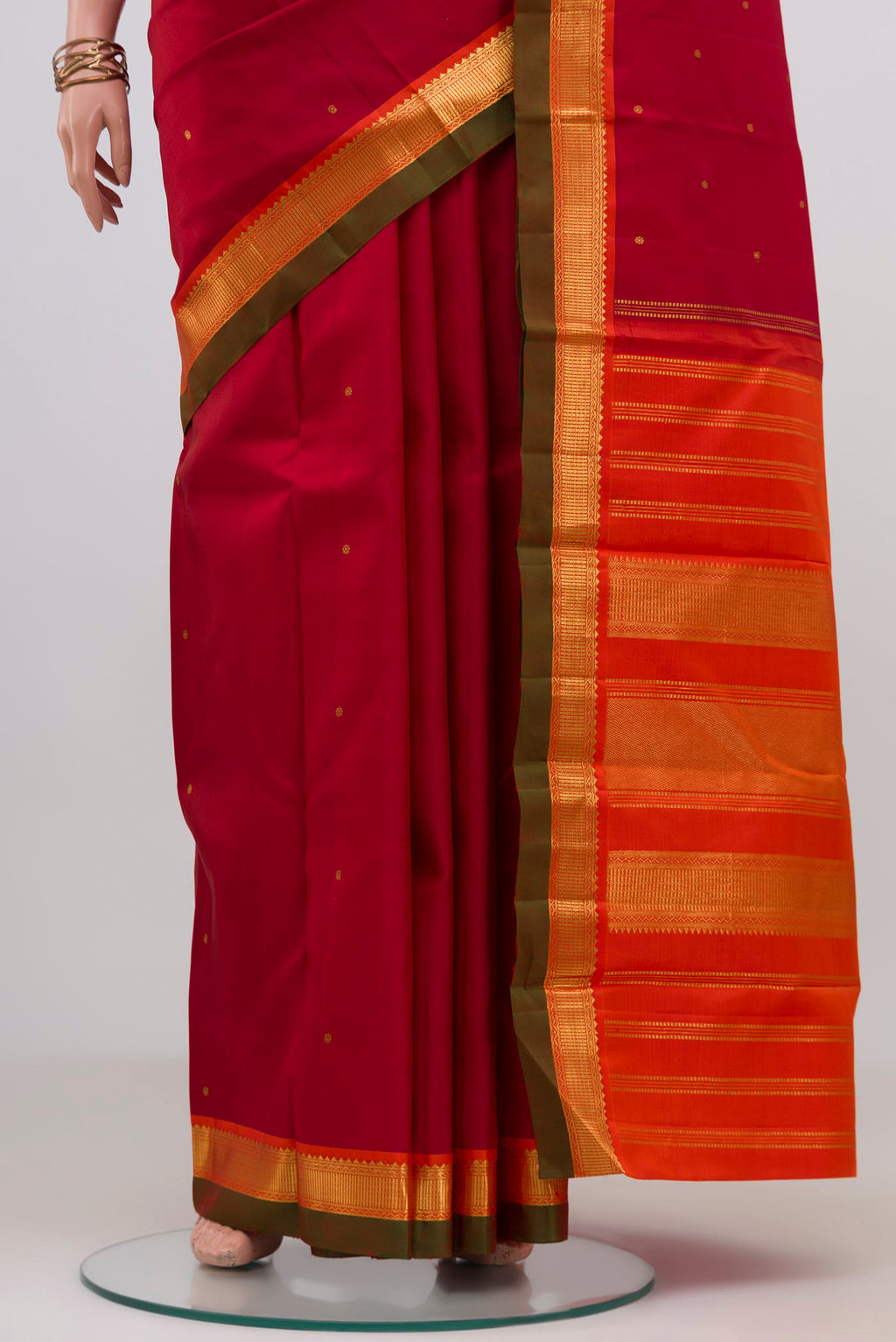 Pleats and pallu of Maroon Kanchipuram Silk Saree with Zari Butta on the body and Zari Border. 