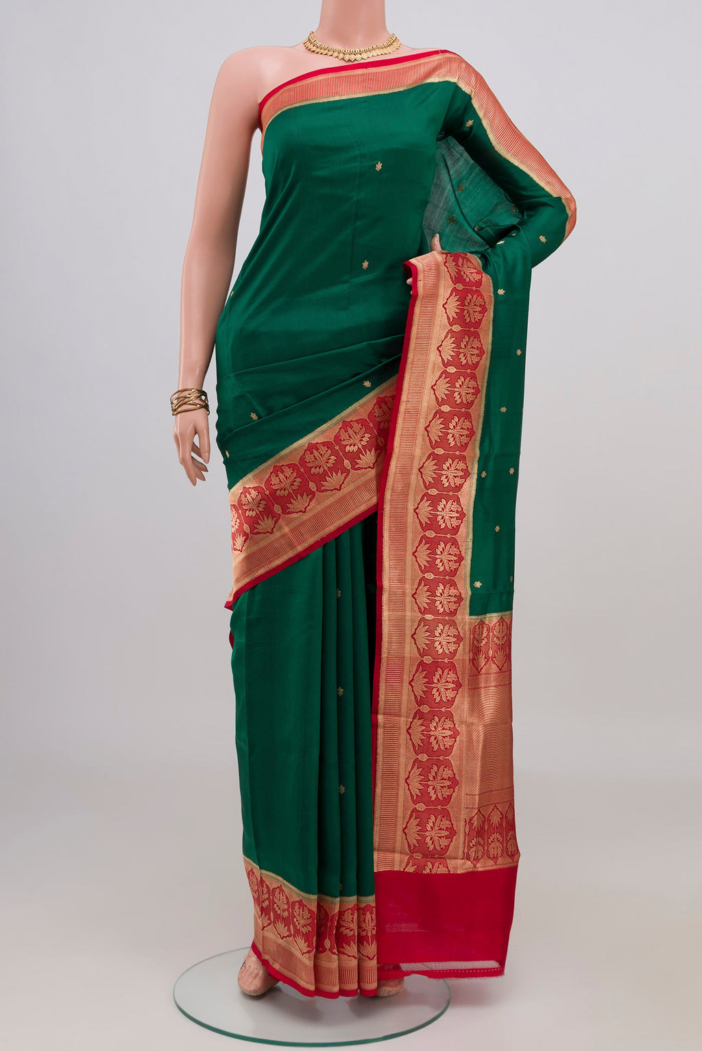 Green Banarasi Katan Silk Saree with Zari Butta on the body and Fancy Border.  displayed on a mannequin
