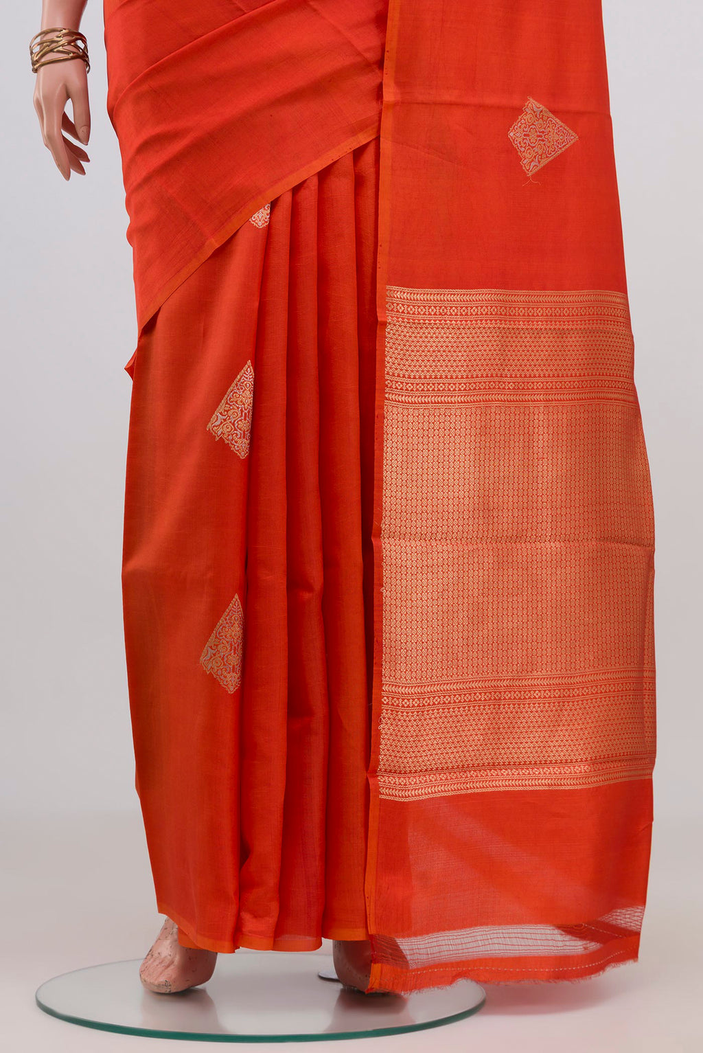 Pleats and pallu of Orange Banarasi Katan Silk Saree with Zari Butta on the body and Without Border. 