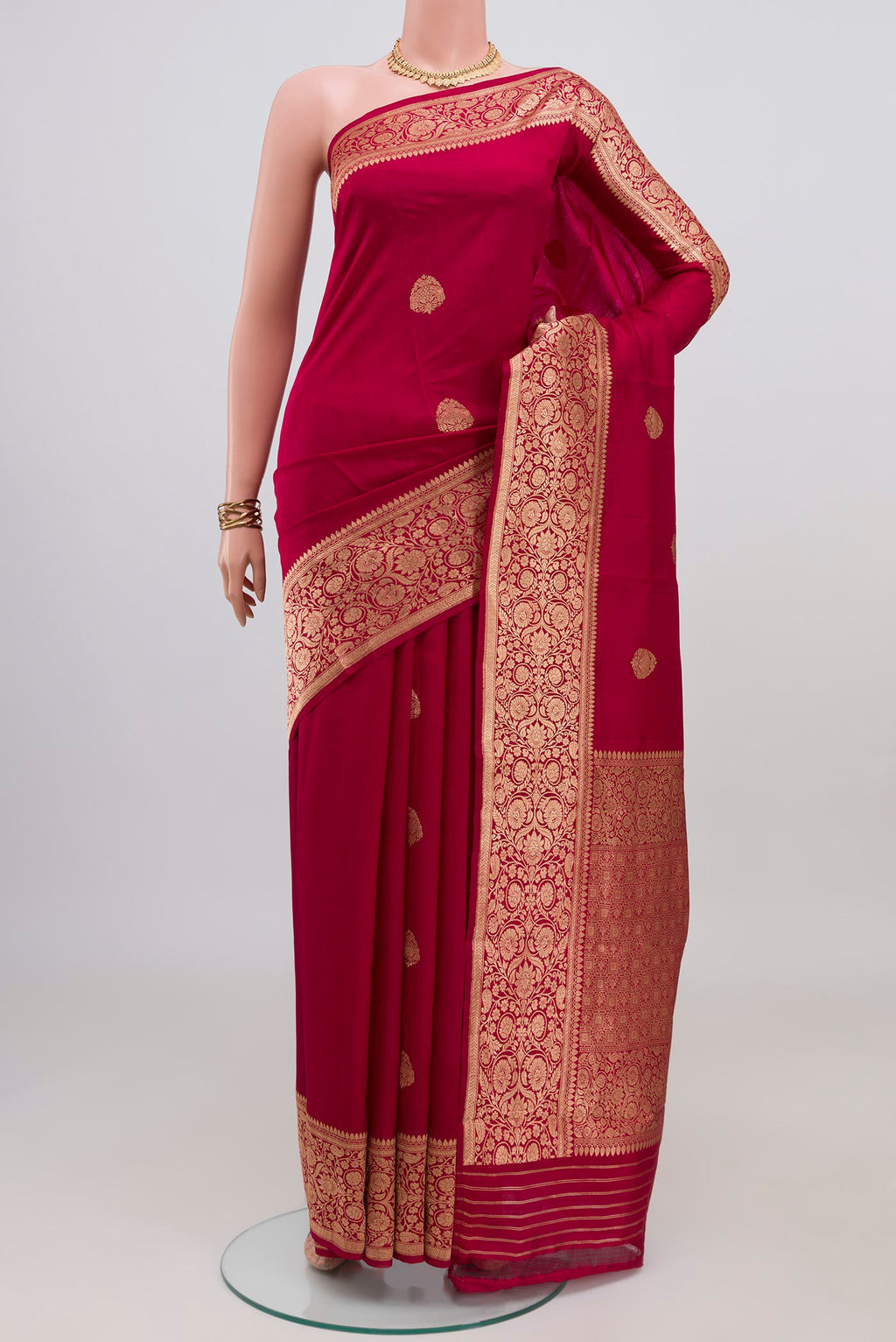 Maroon Banarasi Katan Silk Saree with Zari Butta on the body and Zari Border.  displayed on a mannequin