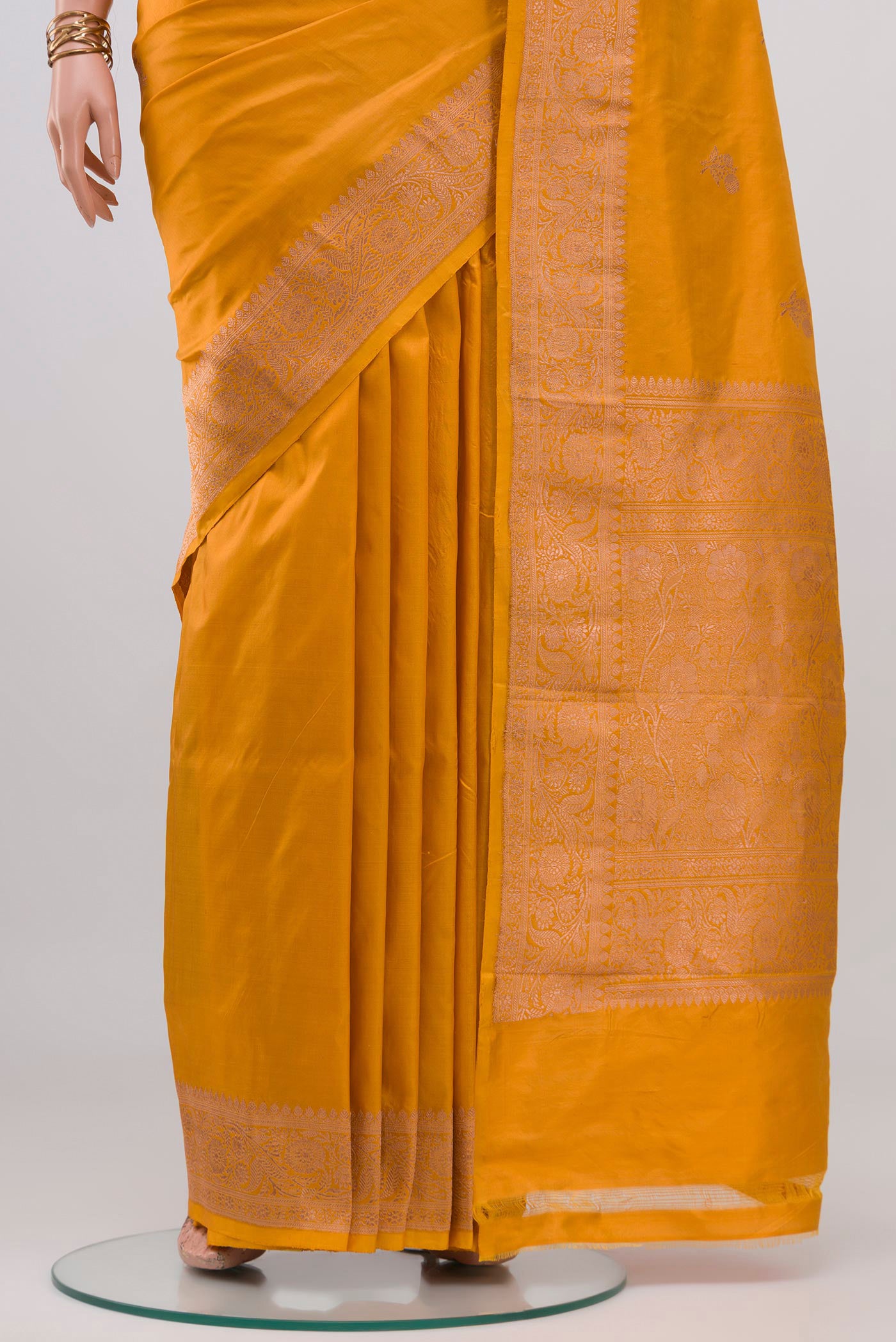 Pleats and pallu of Mustard Banarasi Katan Silk Saree with Zari Butta on the body and Zari Border. 