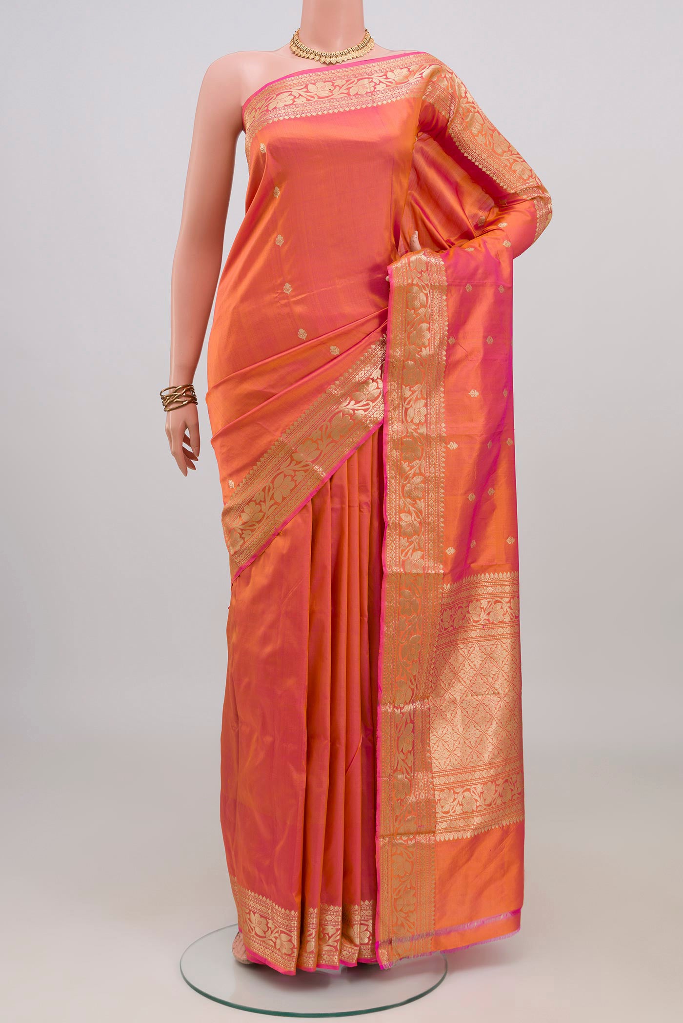 Peach Dual Tone Banarasi Katan Silk Saree with Zari Butta on the body and Zari Border.  displayed on a mannequin