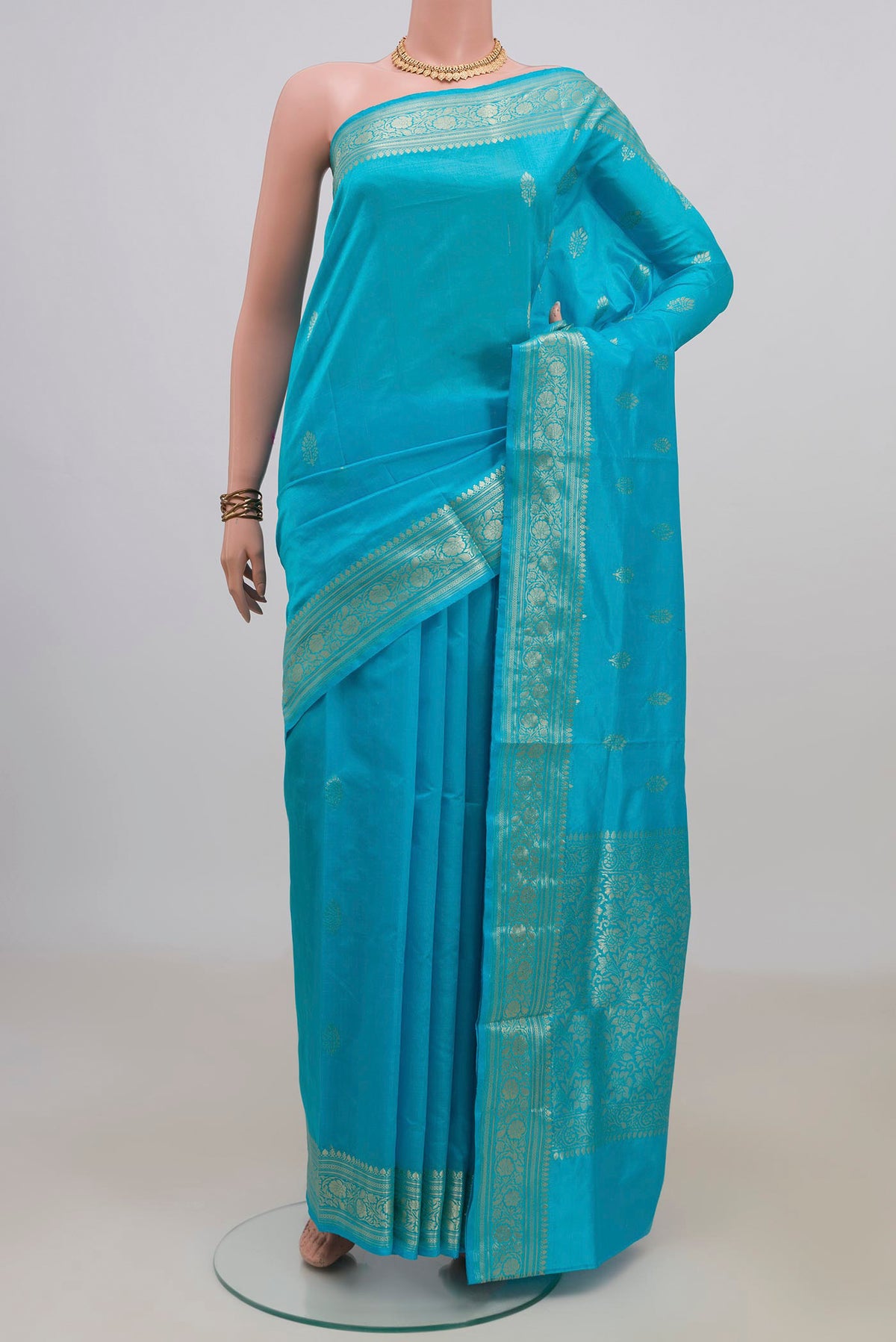 Pure Silk Light Blue Banarasi Katan Saree with Zari Butta on the body and Zari Border.  displayed on a mannequin