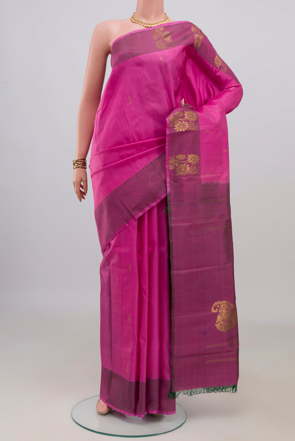 Pure Silk Pink Kanchipuram Saree with Zari Butta on the body and Fancy Border.  displayed on a mannequin