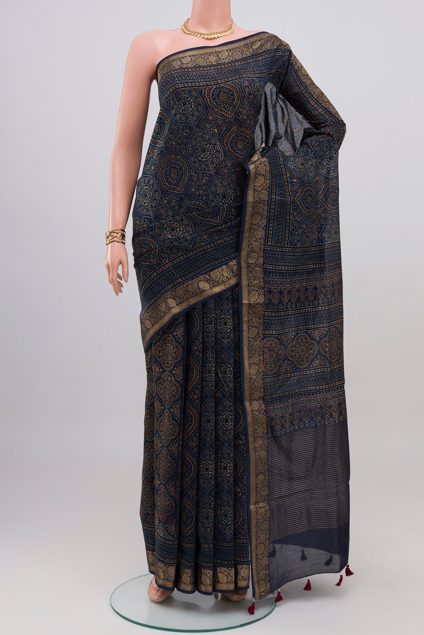 Navy Blue Chanderi Silk Cotton Saree with Ajrakh Print on the body and Zari Border.  displayed on a mannequin