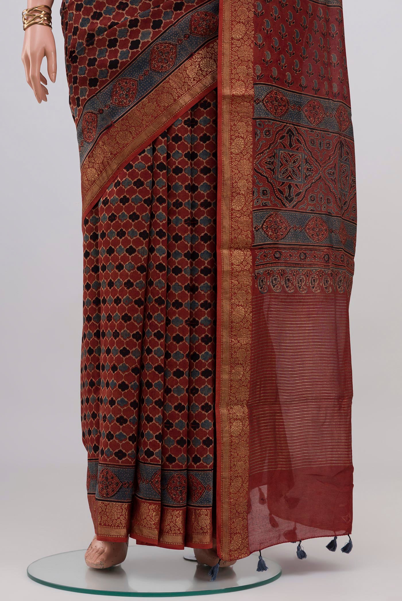 Pleats and pallu of Rust Chanderi Silk Cotton Saree with Ajrakh Print on the body and Zari Border. 