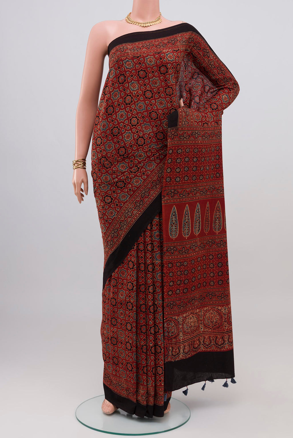 Rust Blended Chanderi Silk Cotton Saree with Ajrakh Print on the body and Printed Border.  displayed on a mannequin