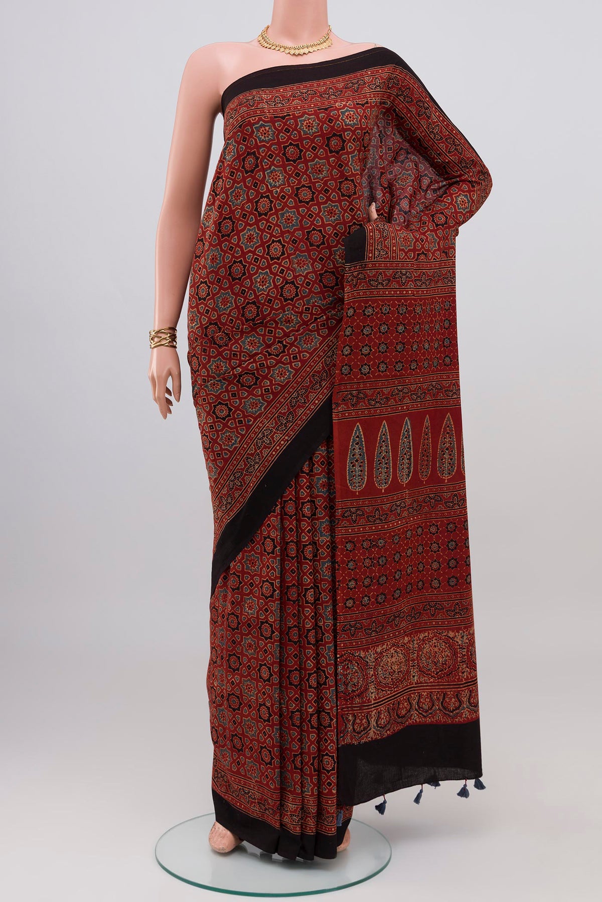 Rust Blended Chanderi Silk Cotton Saree with Ajrakh Print on the body and Printed Border.  displayed on a mannequin