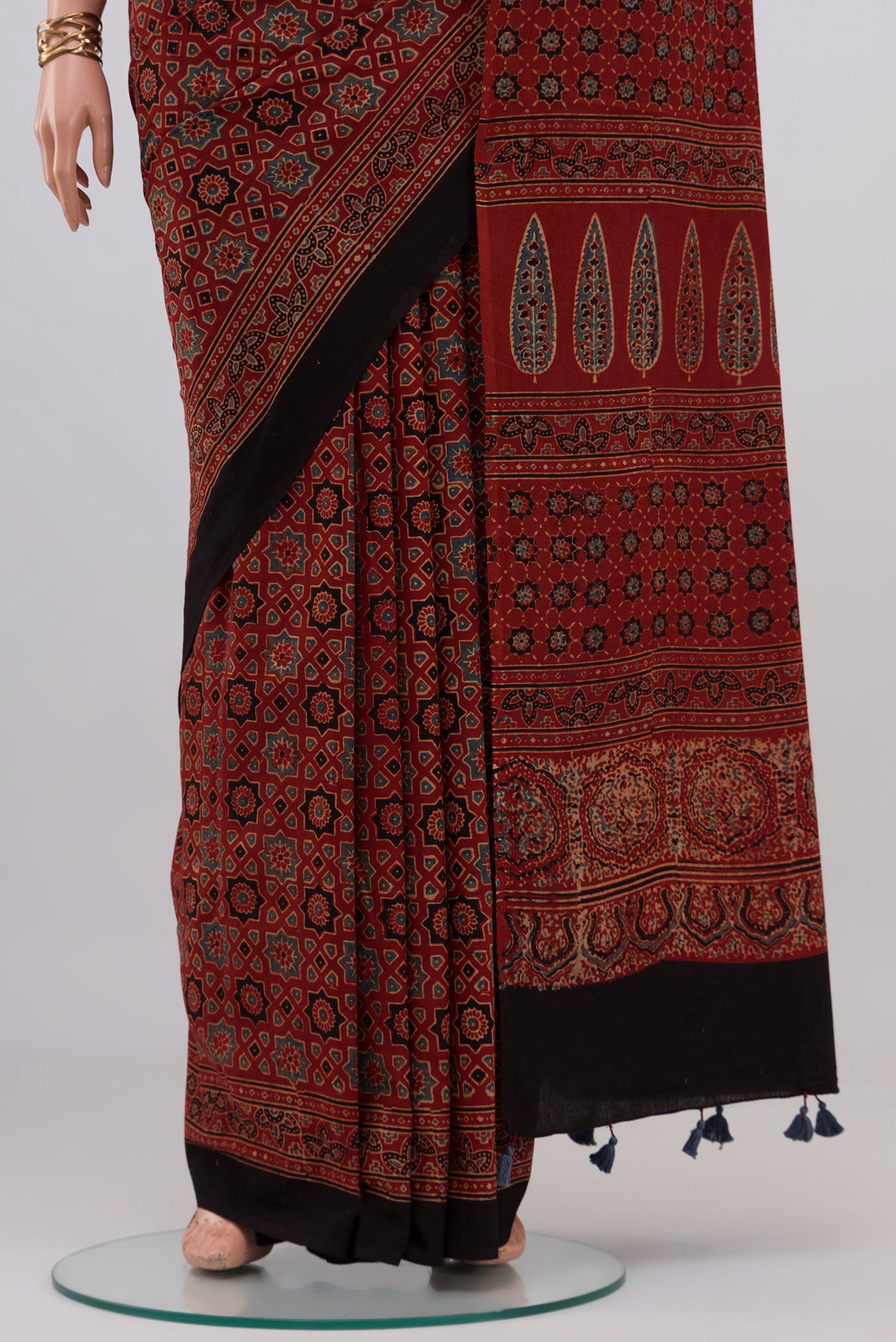 Pleats and pallu of Rust Blended Chanderi Silk Cotton Saree with Ajrakh Print on the body and Printed Border. 