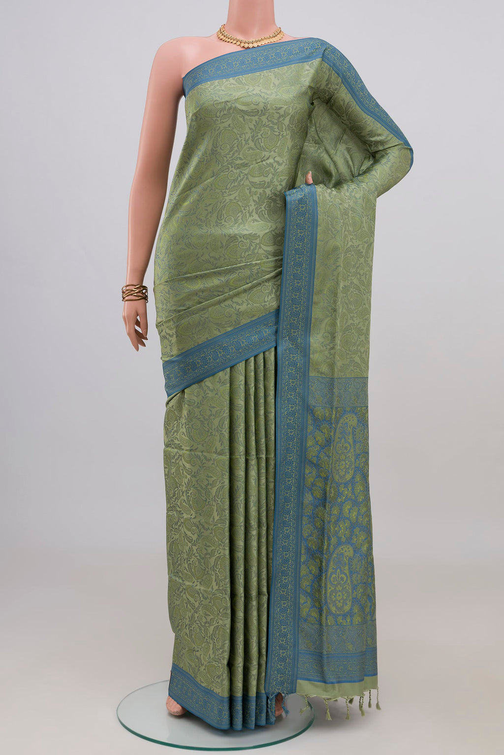 Light Green Soft Silk Saree with Jacquard design on the body and Thread Border.  displayed on a mannequin