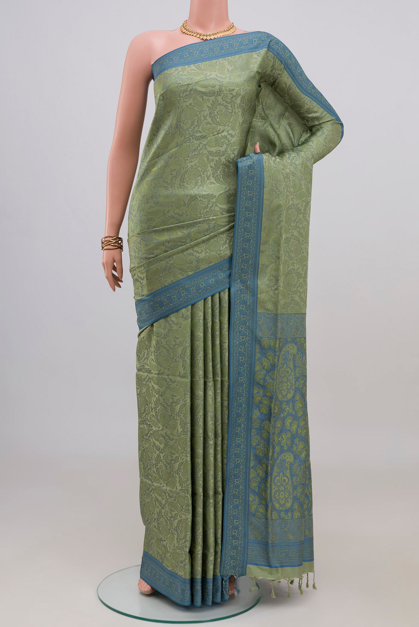 Light Green Soft Silk Saree with Jacquard design on the body and Thread Border.  displayed on a mannequin