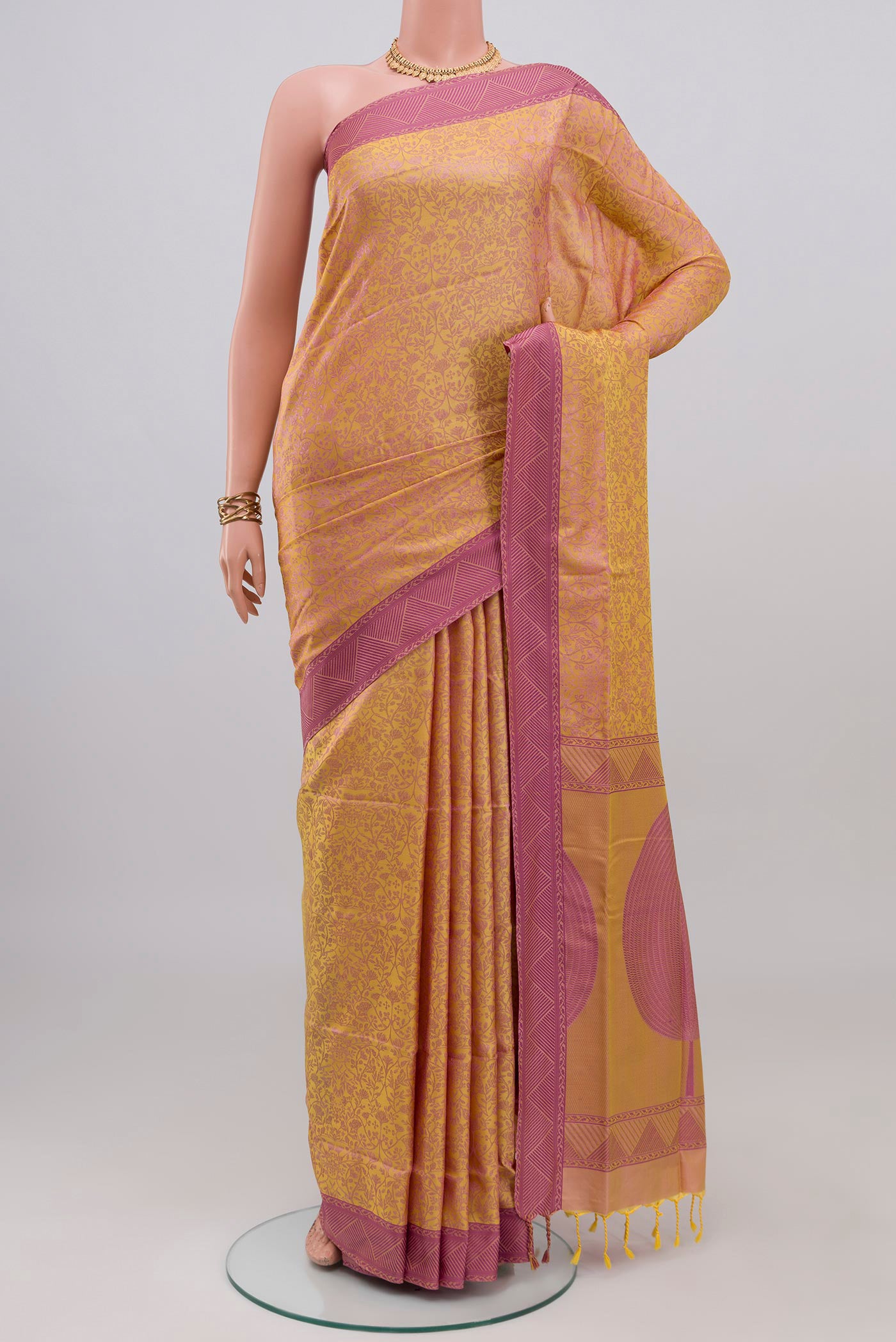 Pinkish Yellow Soft Silk Saree with Jacquard design on the body and Thread Border.  displayed on a mannequin
