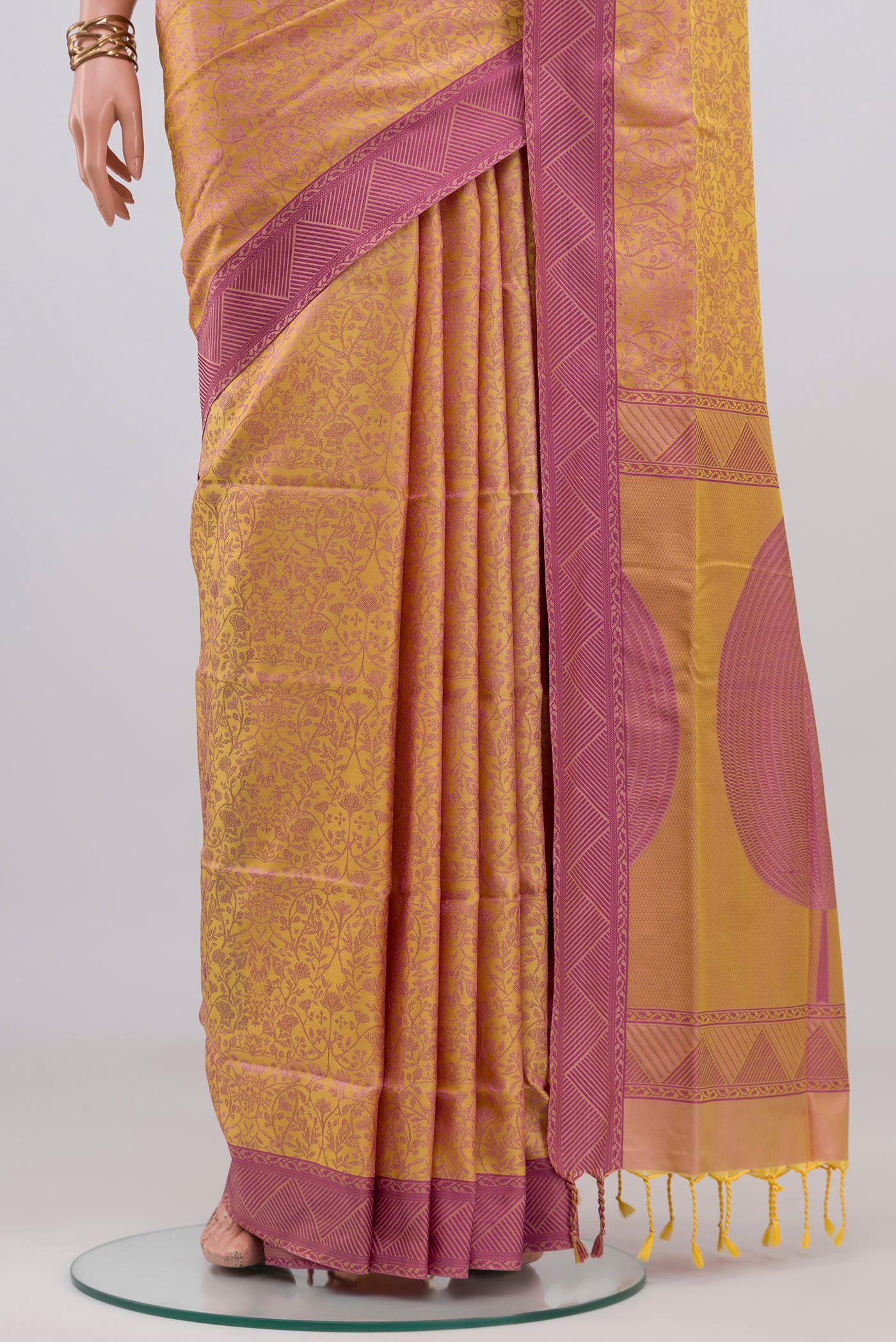 Pleats and pallu of Pinkish Yellow Soft Silk Saree with Jacquard design on the body and Thread Border. 