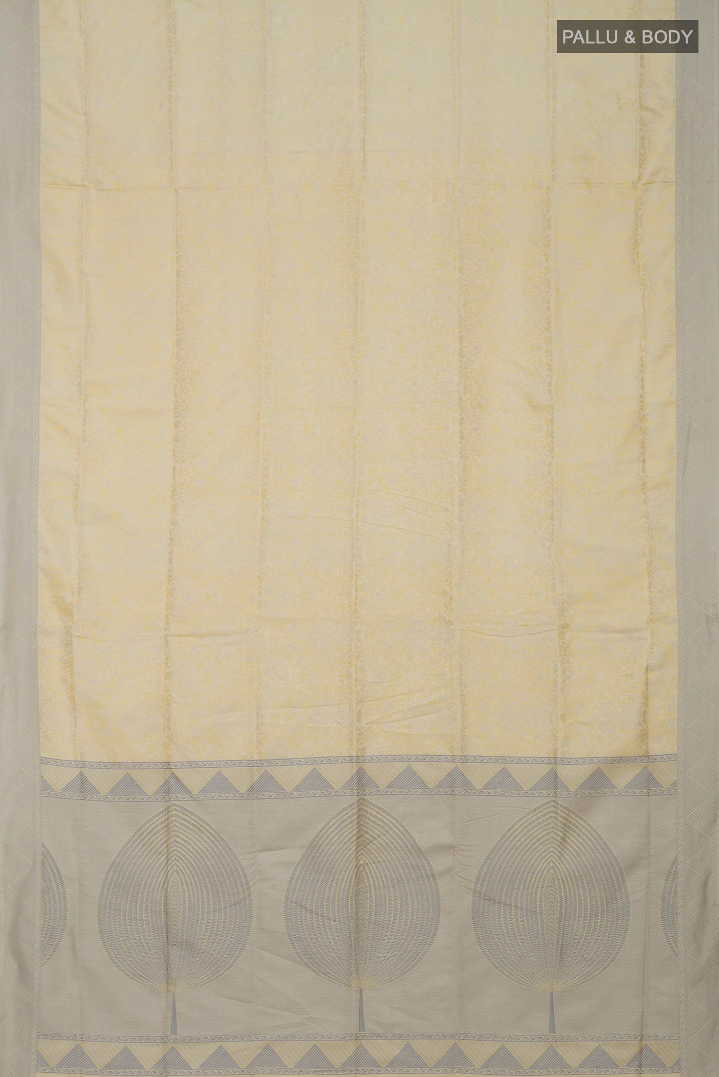 Flat view of Cream Soft Silk Saree with Jacquard design on the body and Thread Border. 