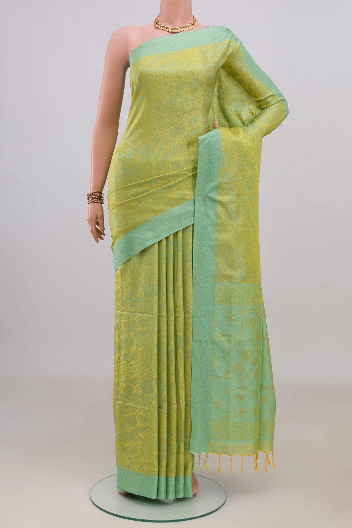 Pure Silk Green Soft Saree with Jacquard design on the body and Thread Border.  displayed on a mannequin