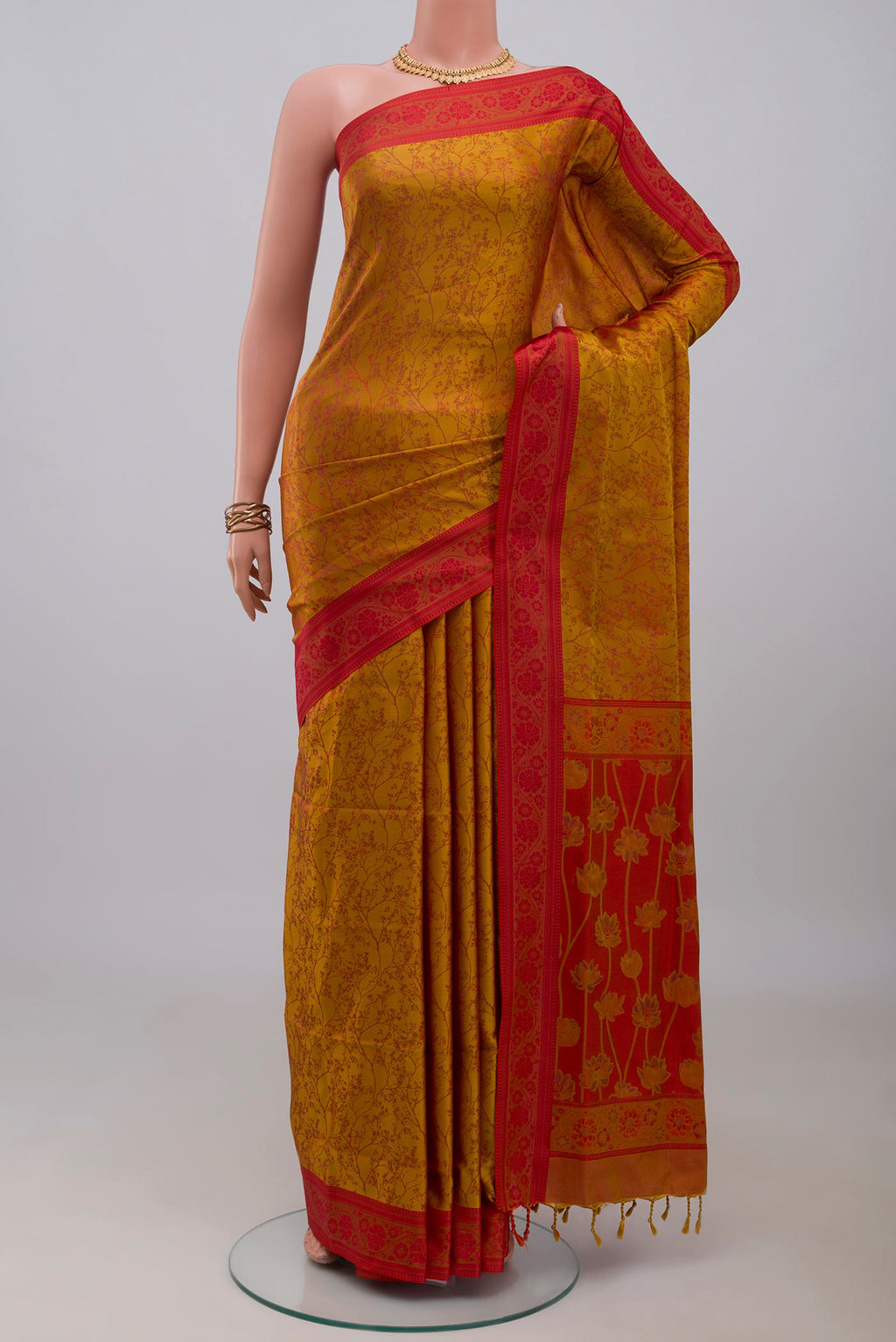 Mustard Soft Silk Saree with Jacquard design on the body and Thread Border.  displayed on a mannequin