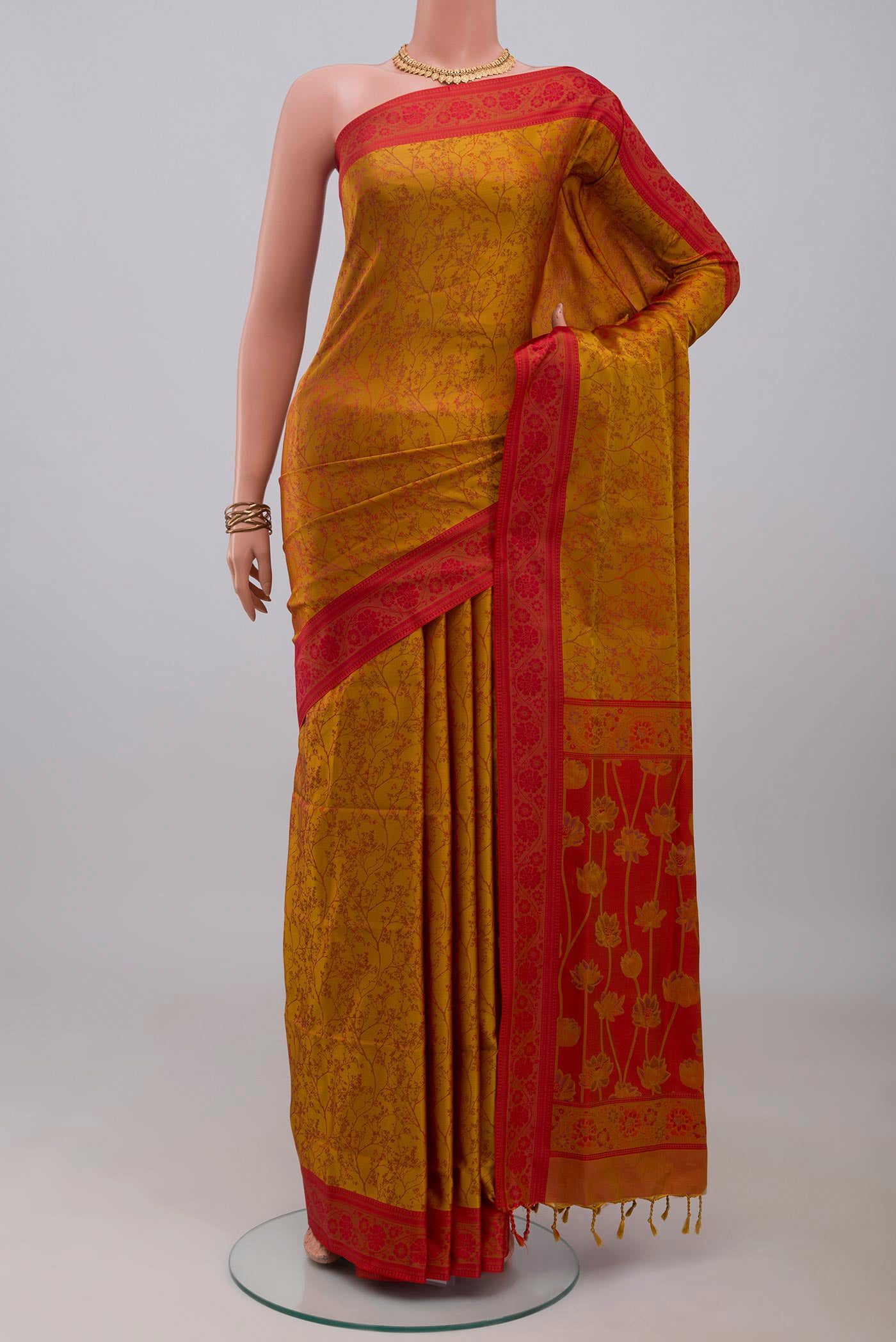 Mustard Soft Silk Saree with Jacquard design on the body and Thread Border.  displayed on a mannequin