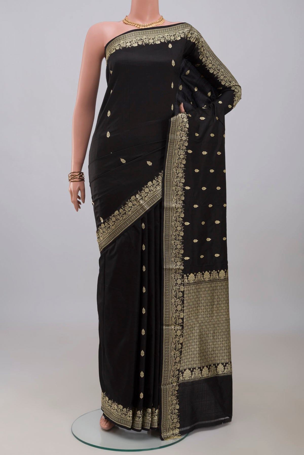 Black Banarasi Katan Silk Saree with Thread Butta on the body and Thread Border.  displayed on a mannequin