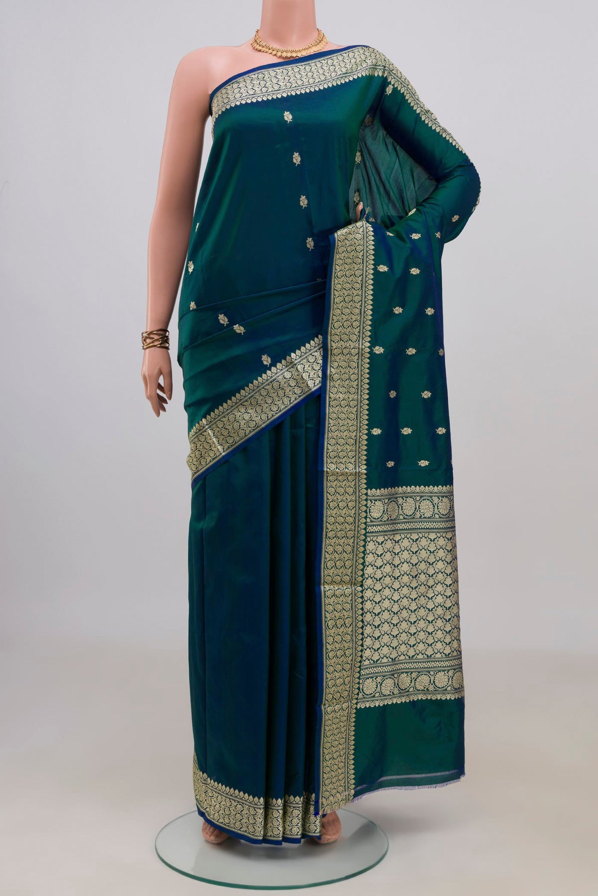 Pure Silk Peacock Blue Dual Tone Banarasi Katan Saree with Zari Butta on the body and Zari Border.  displayed on a mannequin