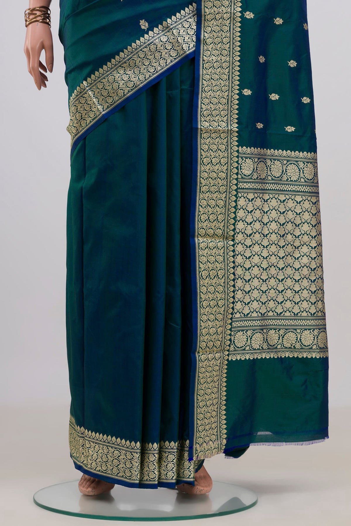 Pleats and pallu of Pure Silk Peacock Blue Dual Tone Banarasi Katan Saree with Zari Butta on the body and Zari Border. 