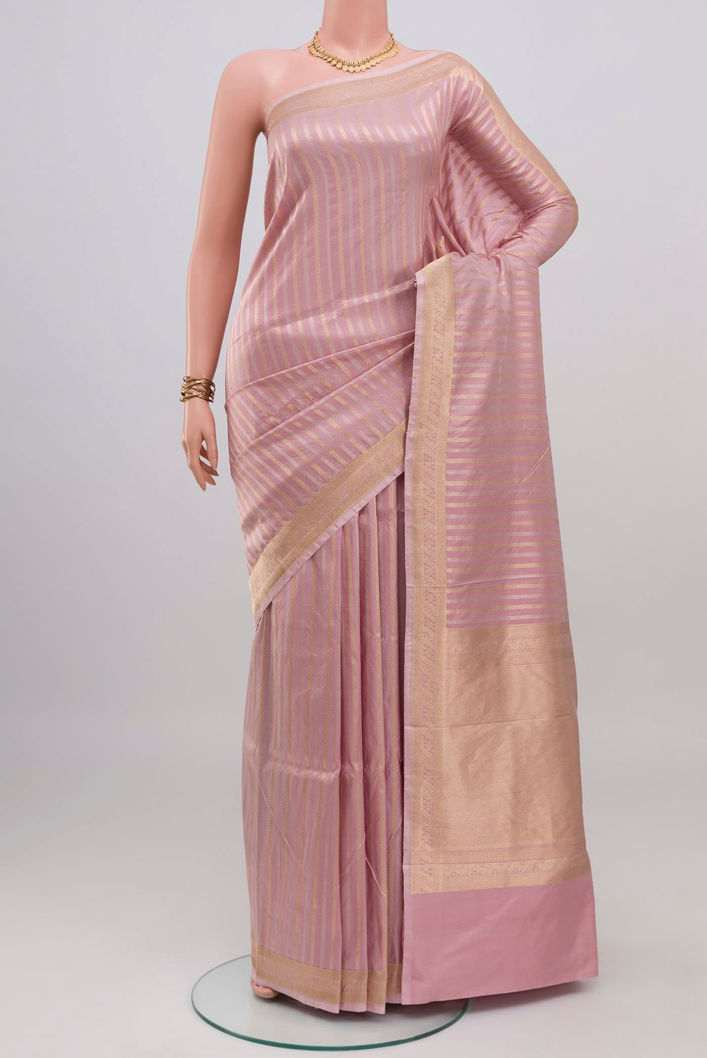 Rose pink Banarasi Katan Silk Saree with Stripes on the body and Zari Border.  displayed on a mannequin