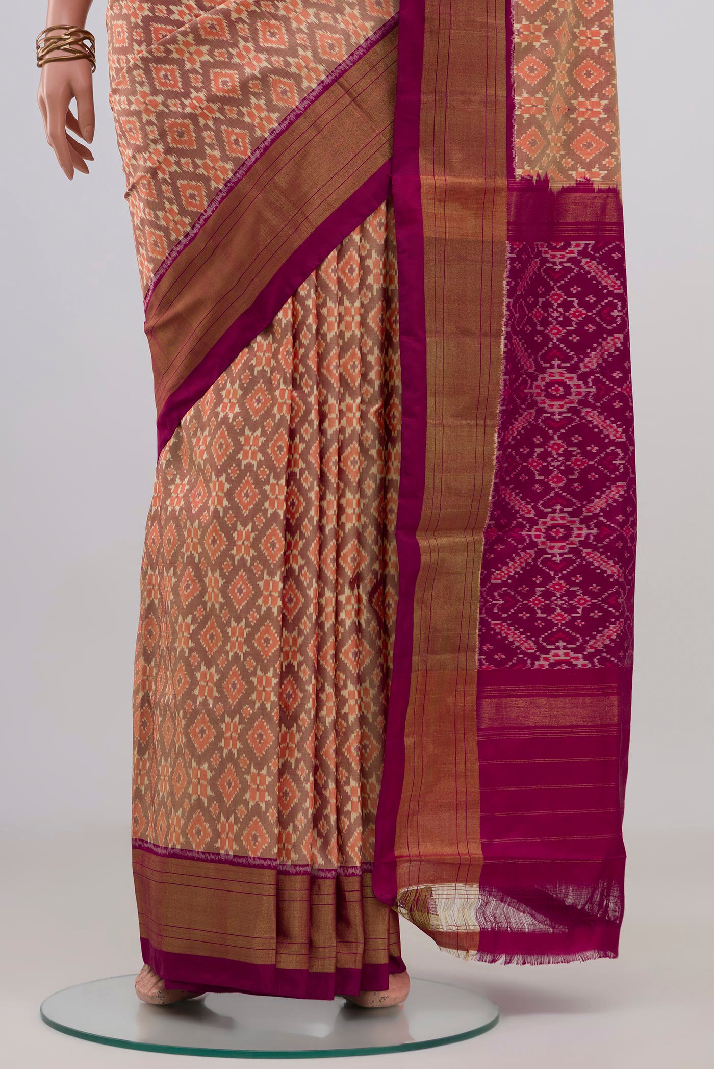 Pleats and pallu of Peach Pochampally Silk Saree with Ikat design on the body and Zari Border. 