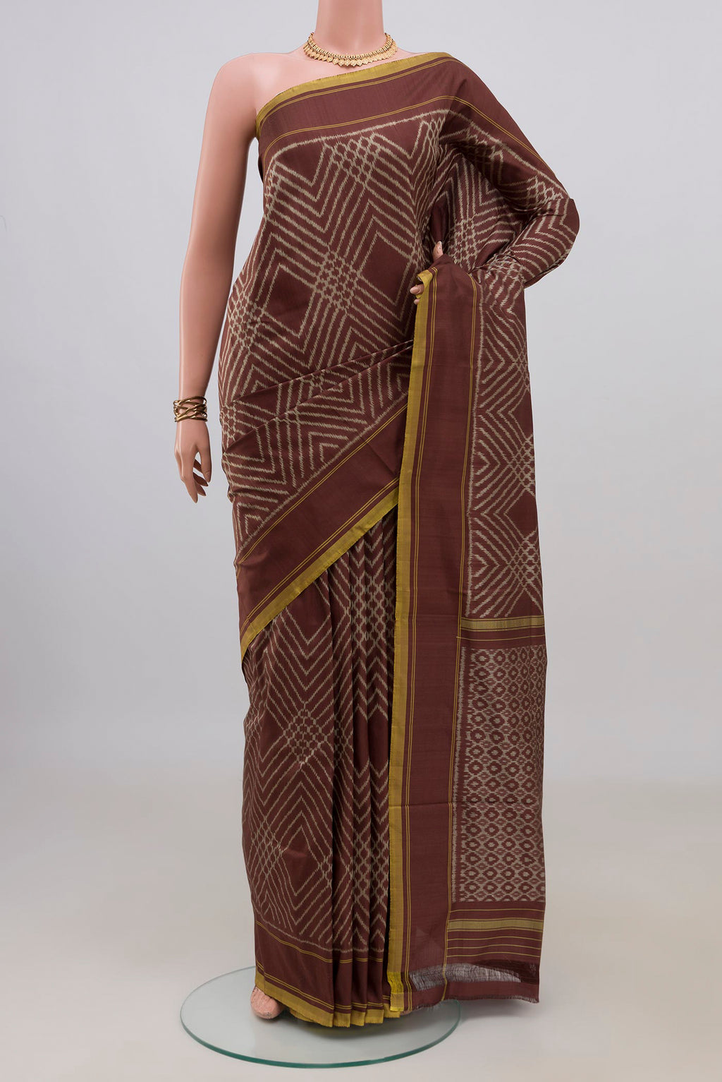 Pure Silk Brown Pochampally Saree with Ikat design on the body and Plain Border.  displayed on a mannequin