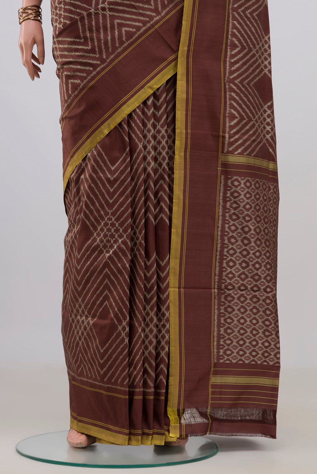 Pleats and pallu of Pure Silk Brown Pochampally Saree with Ikat design on the body and Plain Border. 
