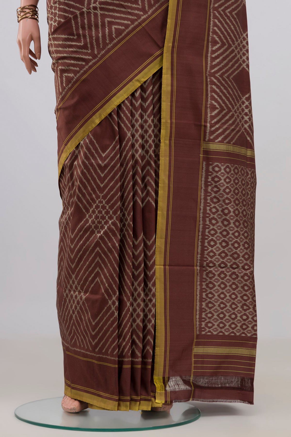 Pleats and pallu of Pure Silk Brown Pochampally Saree with Ikat design on the body and Plain Border. 