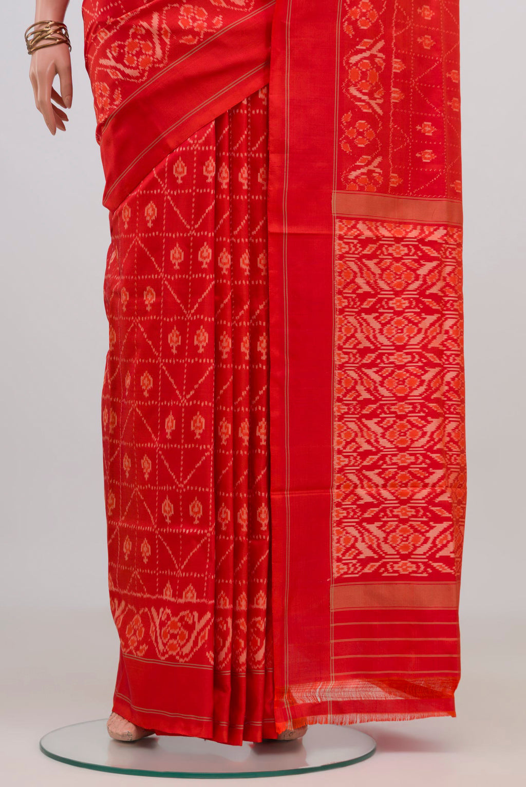 Pleats and pallu of Orange Pochampally Silk Saree with Ikat design on the body and Plain Border. 