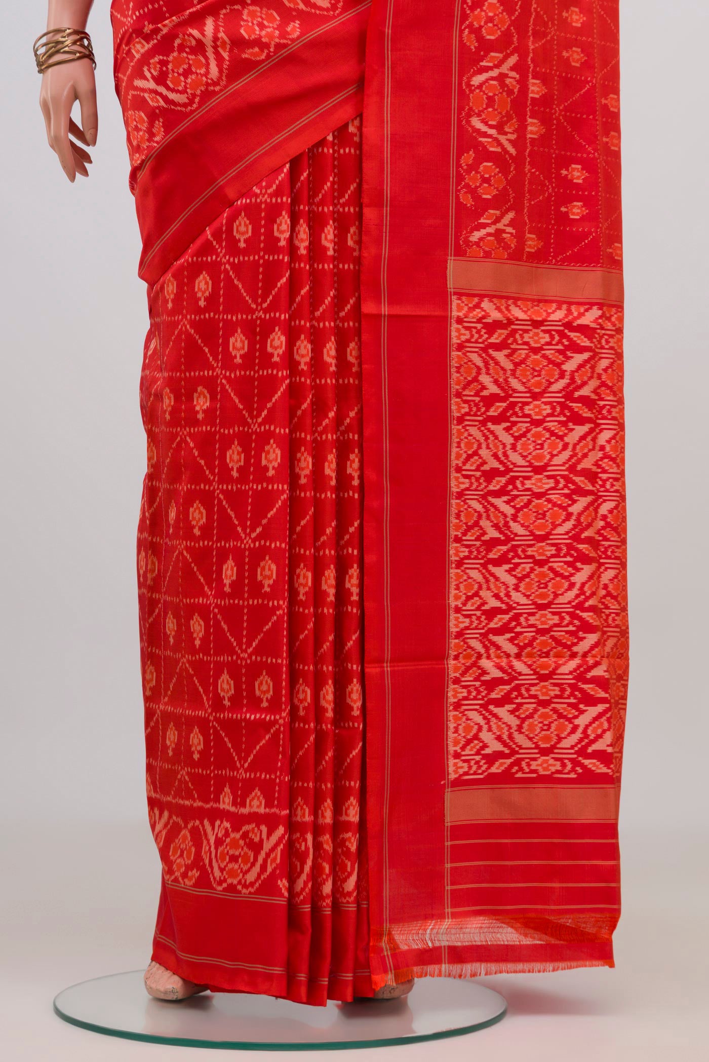 Pleats and pallu of Orange Pochampally Silk Saree with Ikat design on the body and Plain Border. 