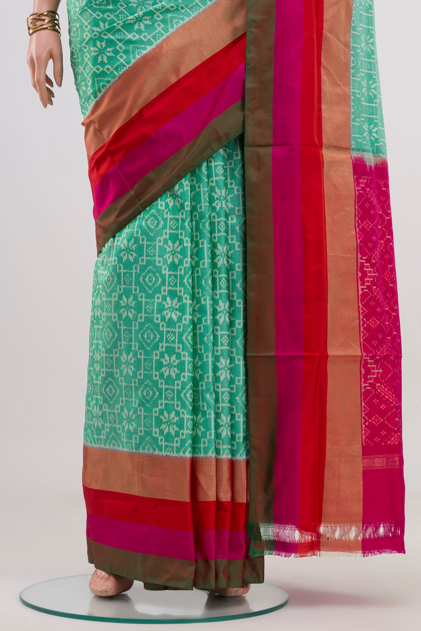Pleats and pallu of Green Pochampally Saree with Ikat design on the body and Zari Border. 
