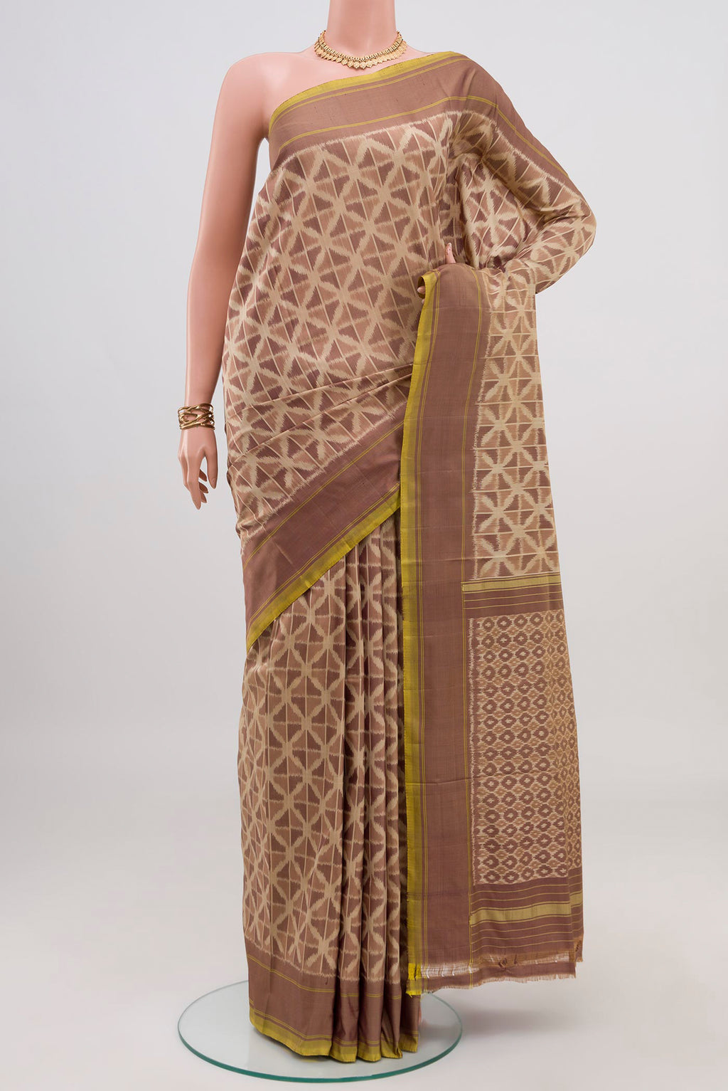 Beige Pochampally Saree with Ikat design on the body and Plain Border.  displayed on a mannequin