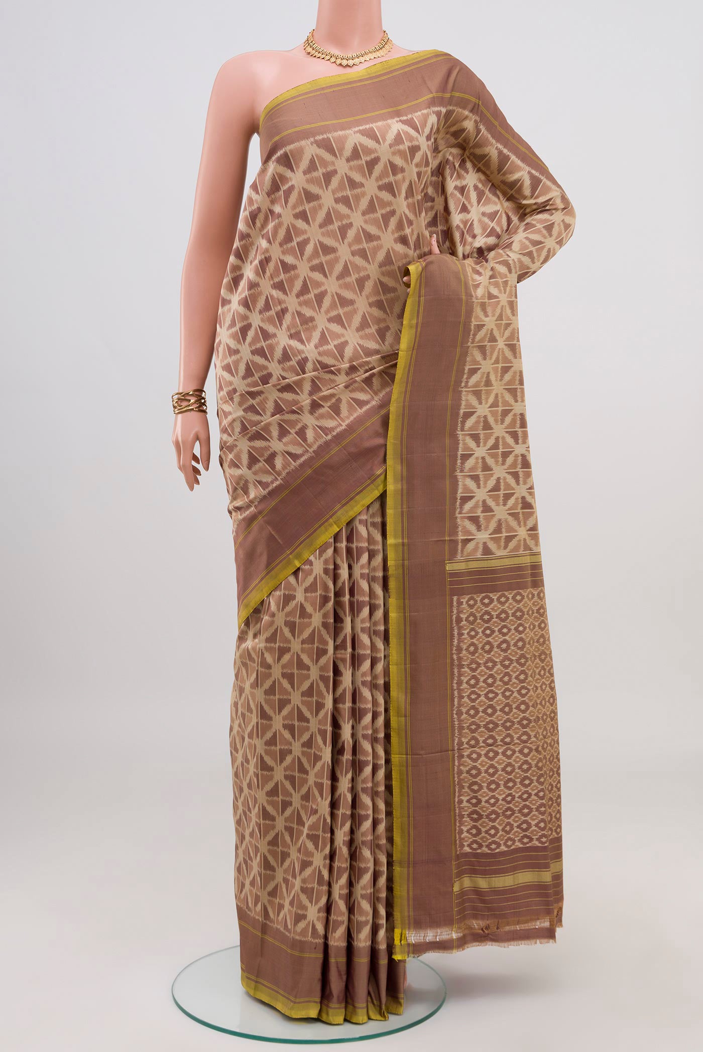 Beige Pochampally Saree with Ikat design on the body and Plain Border.  displayed on a mannequin
