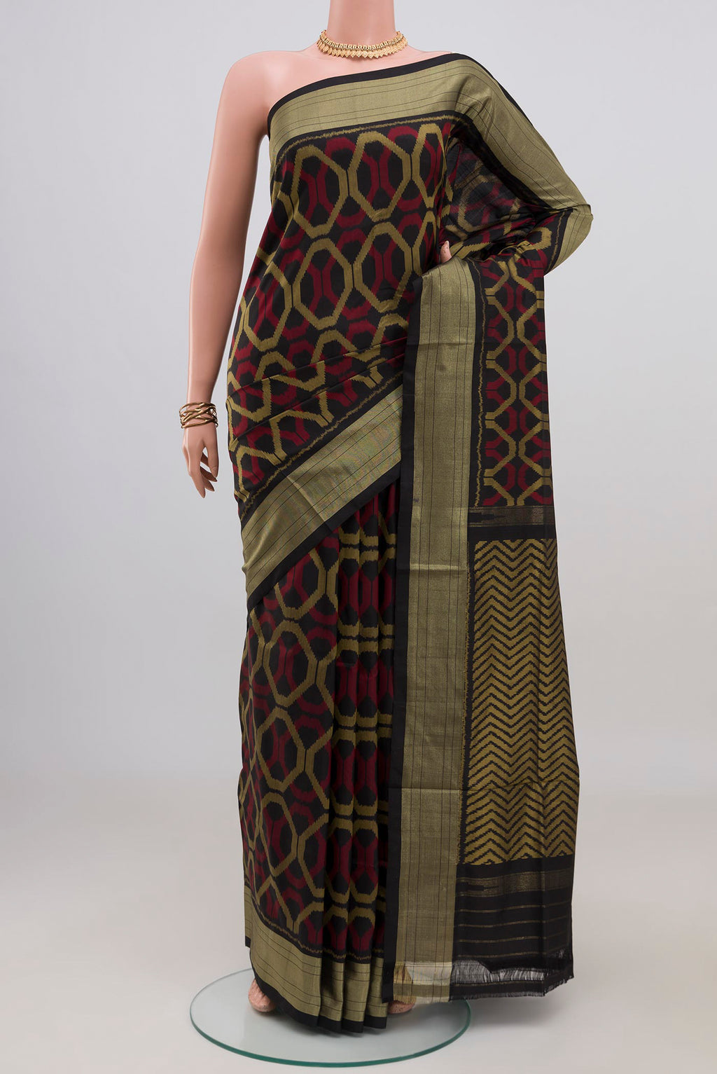 Black Pochampally Silk Saree with Ikat design on the body and Zari Border.  displayed on a mannequin