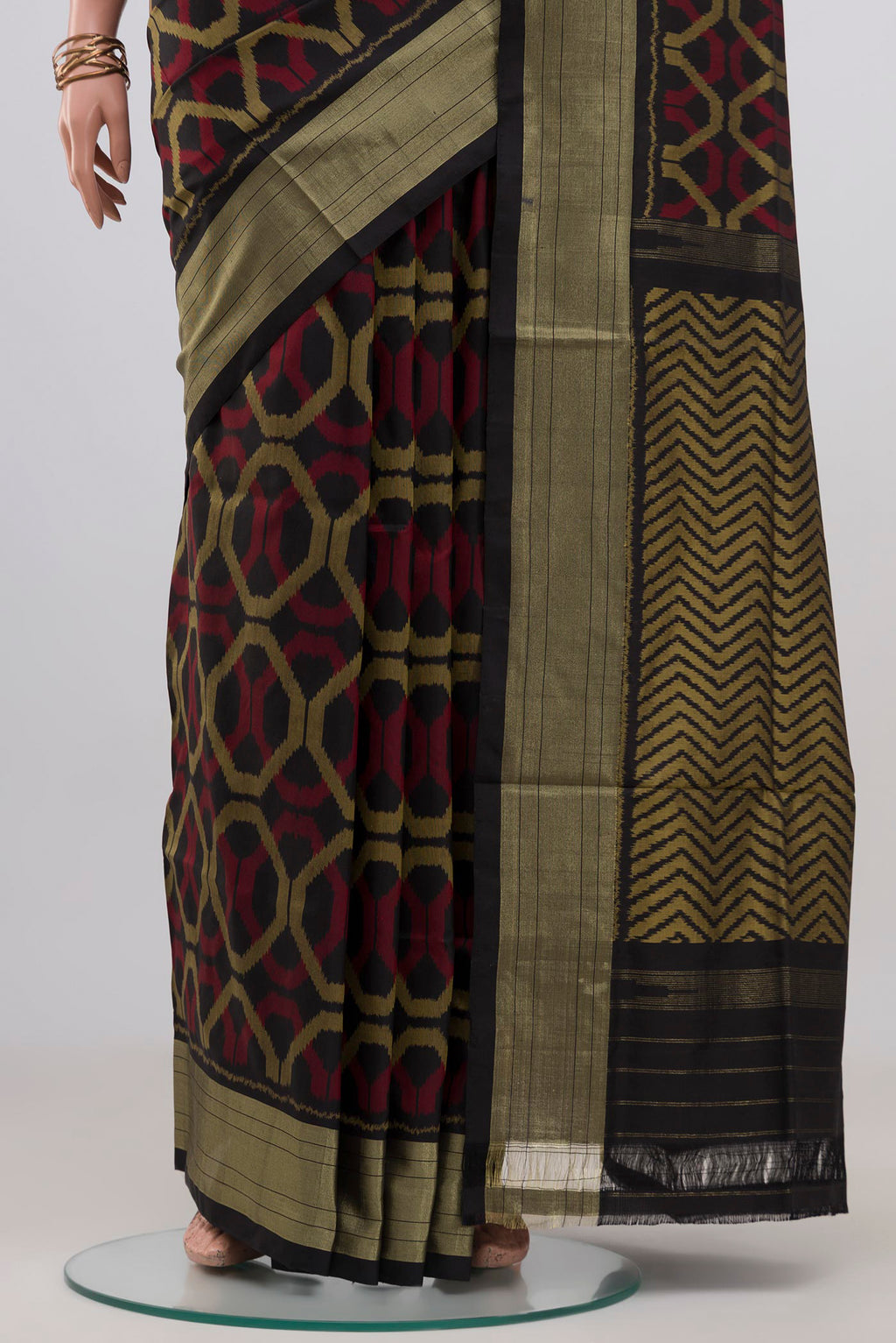 Pleats and pallu of Black Pochampally Silk Saree with Ikat design on the body and Zari Border. 