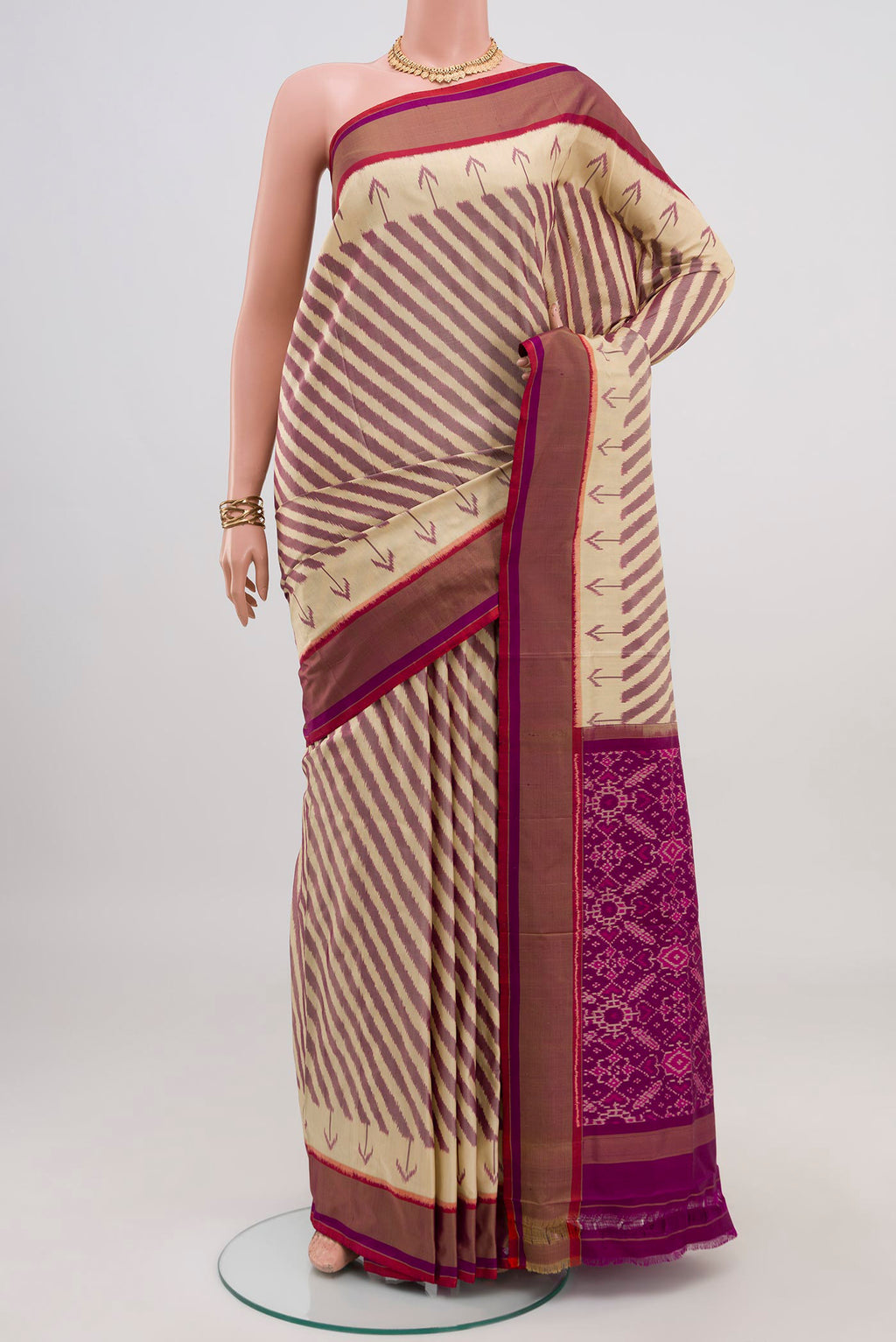 Cream Pochampally Saree with Ikat design on the body and Plain Border.  displayed on a mannequin
