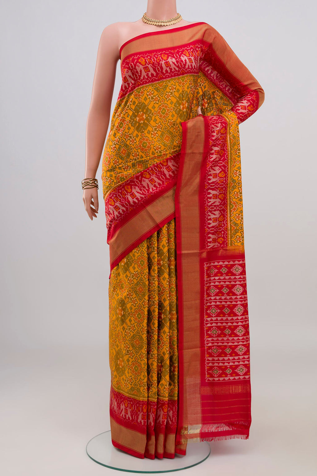Yellow Pochampally Silk Saree with Ikat design on the body and Zari Border.  displayed on a mannequin