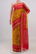 Yellow Pochampally Silk Saree with Ikat design on the body and Zari Border.  displayed on a mannequin
