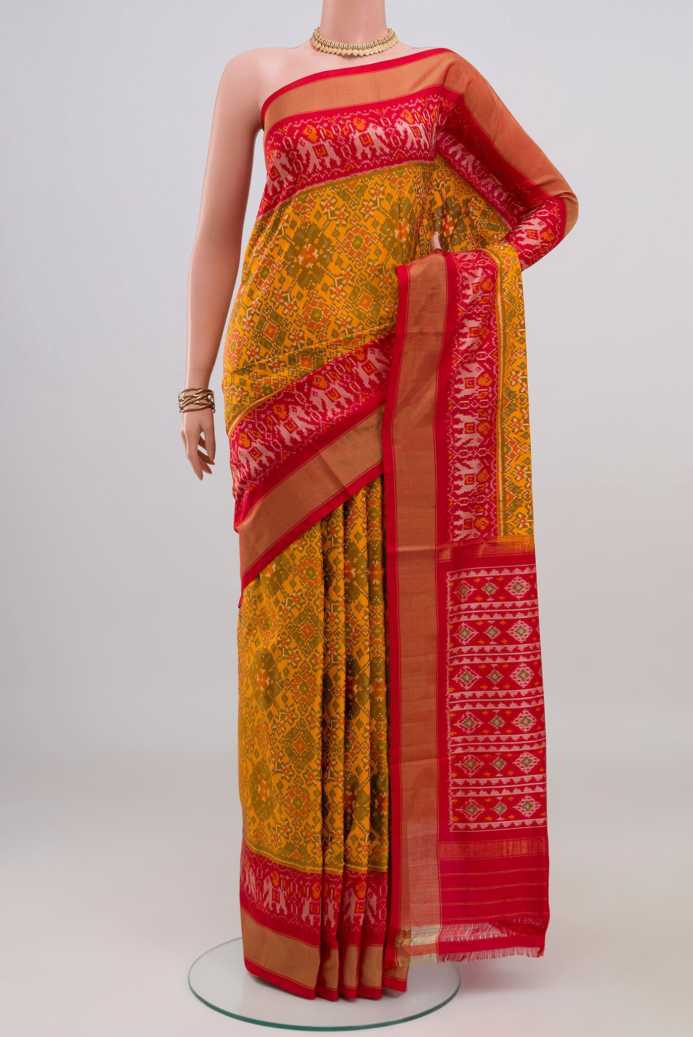 Yellow Pochampally Silk Saree with Ikat design on the body and Zari Border.  displayed on a mannequin