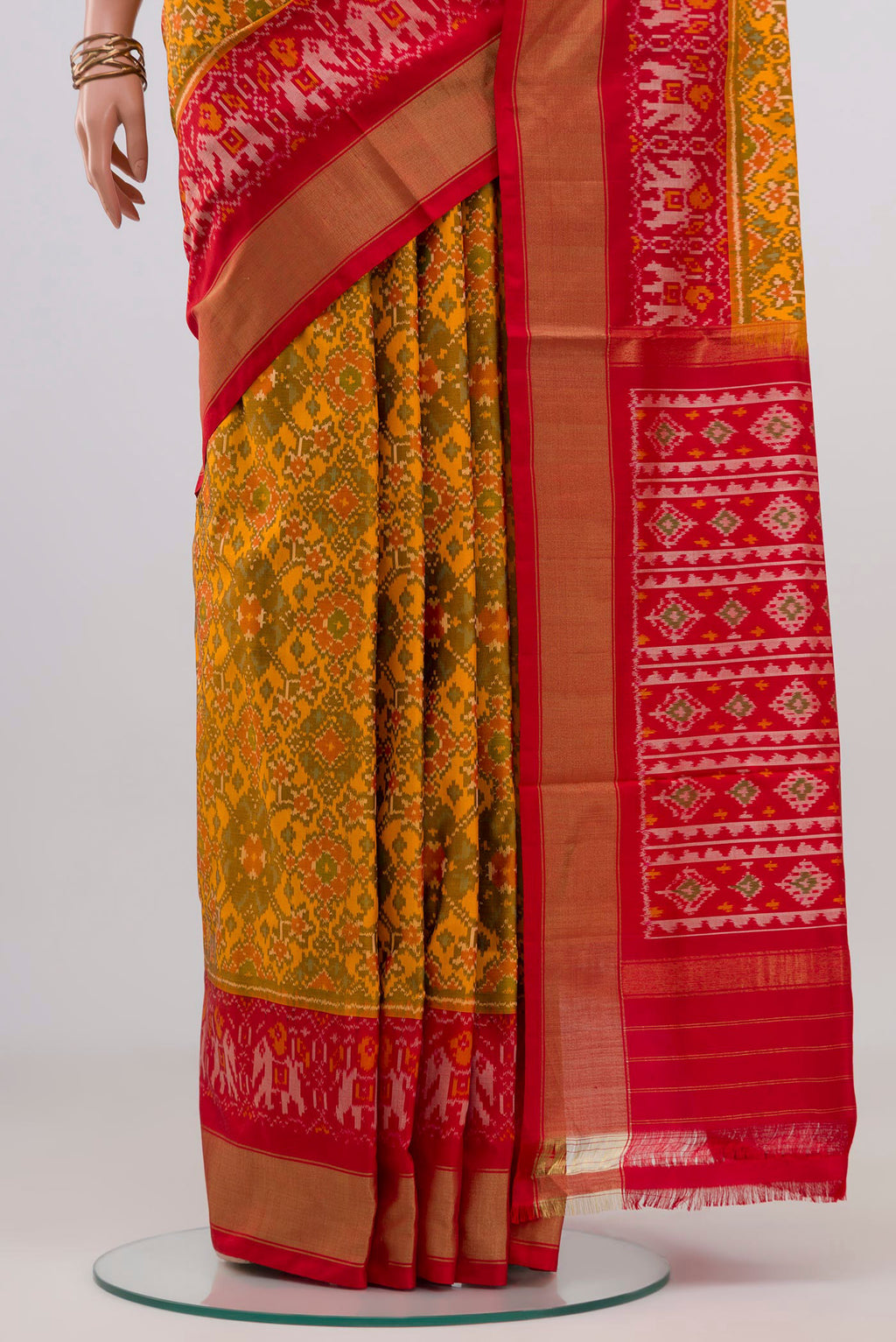 Pleats and pallu of Yellow Pochampally Silk Saree with Ikat design on the body and Zari Border. 