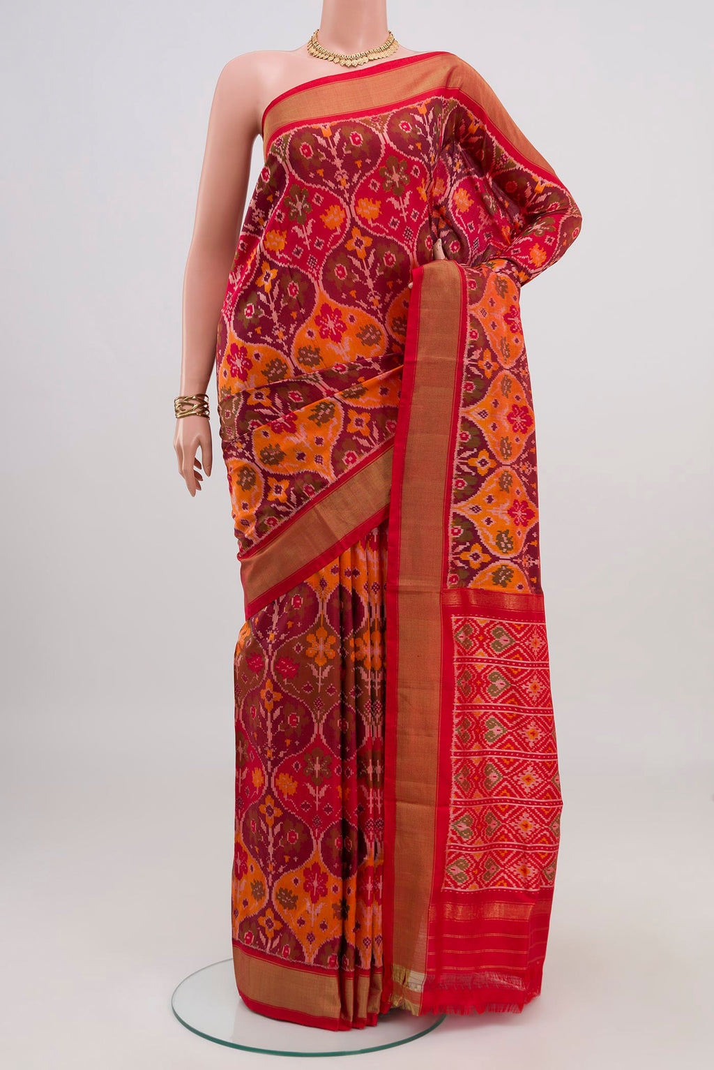 Red Pochampally Saree with Ikat design on the body and Zari Border.  displayed on a mannequin