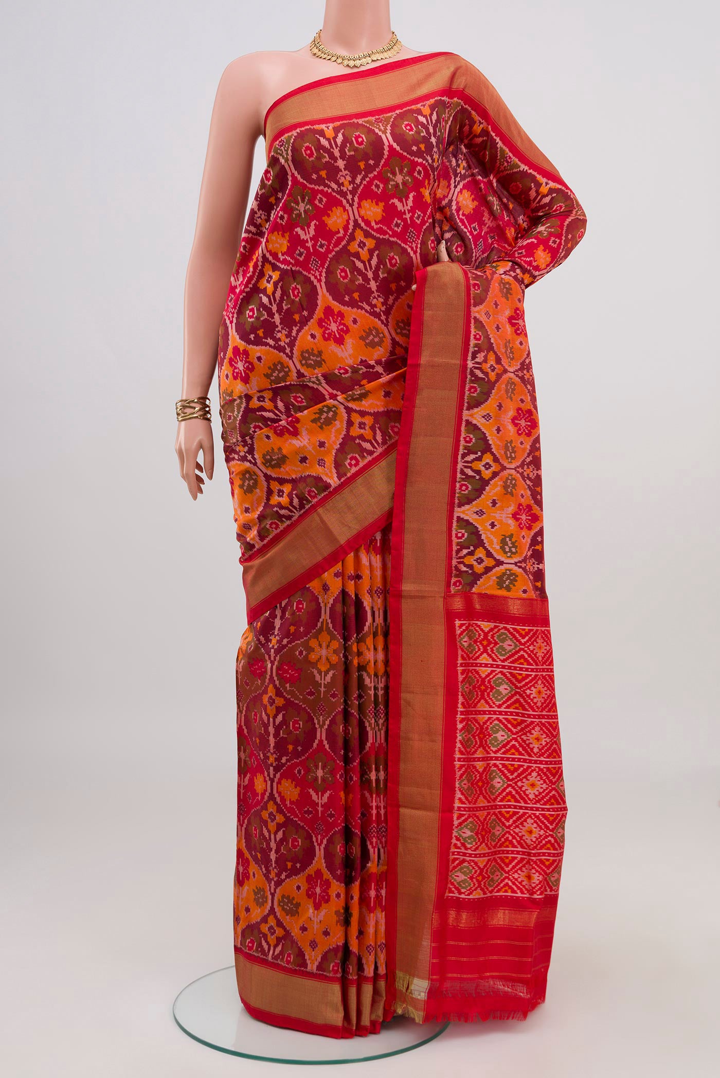 Red Pochampally Saree with Ikat design on the body and Zari Border.  displayed on a mannequin