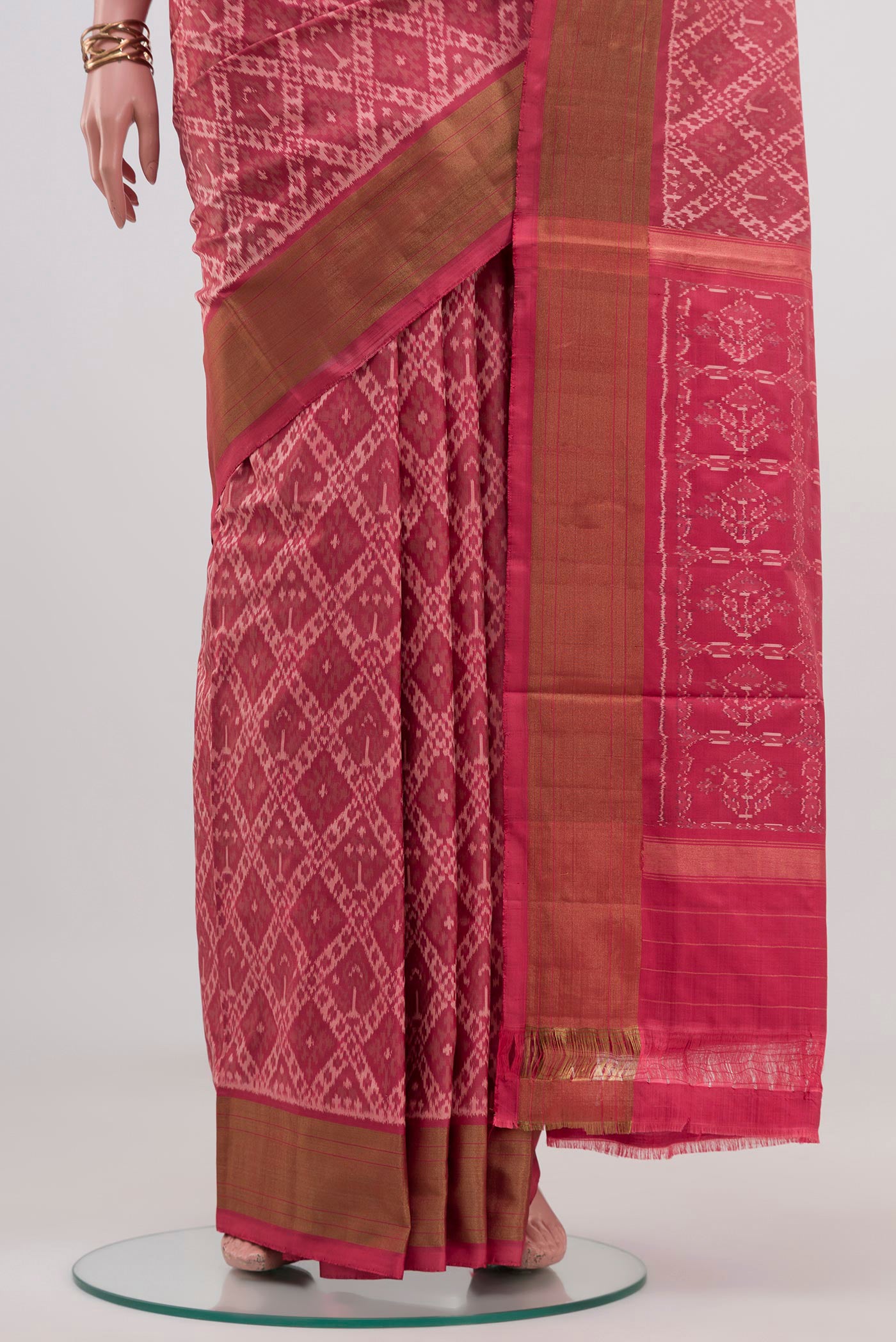 Pleats and pallu of Peach Pochampally Saree with Ikat design on the body and Zari Border. 