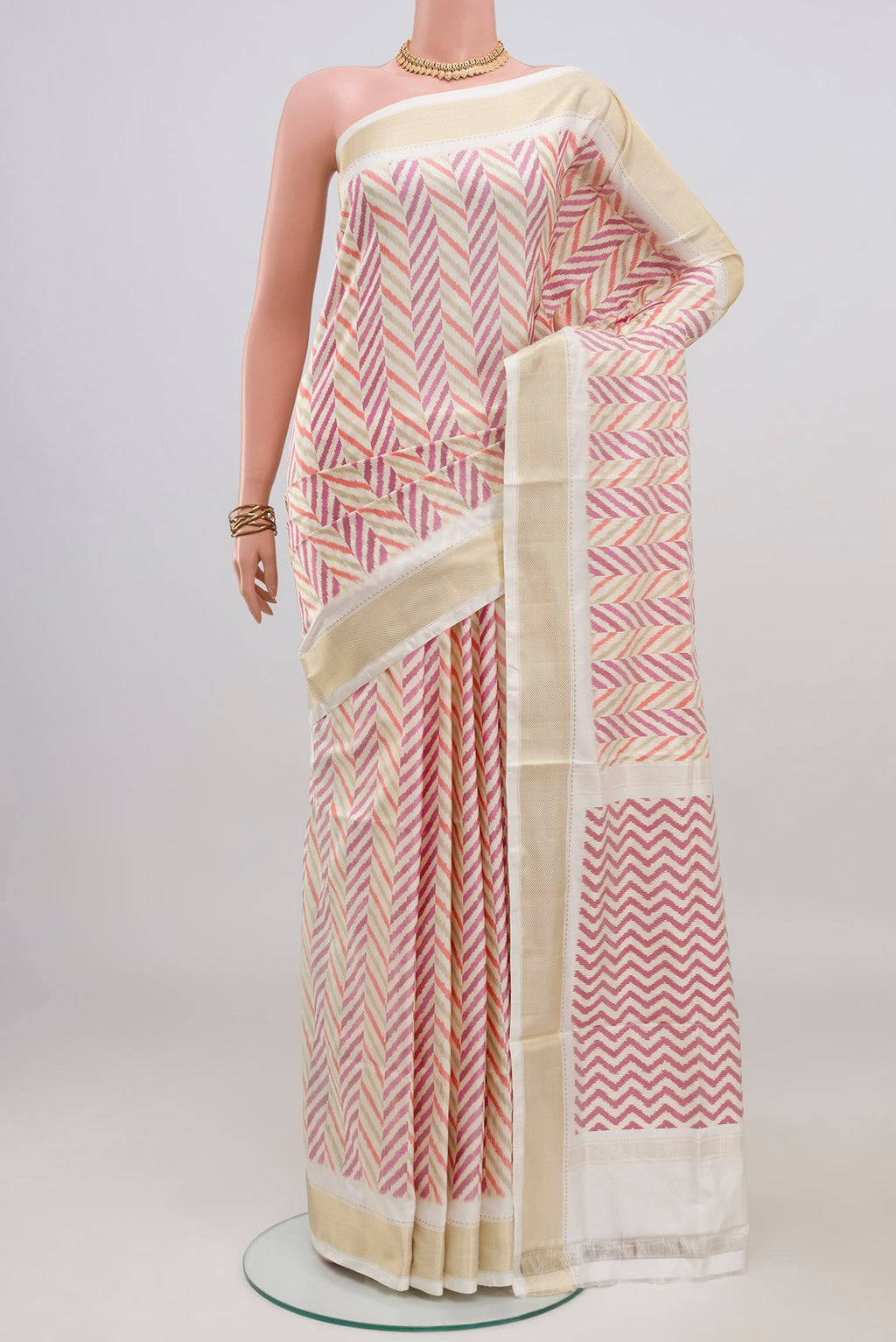 Cream Pochampally Silk Saree with Ikat design on the body and Zari Border.  displayed on a mannequin