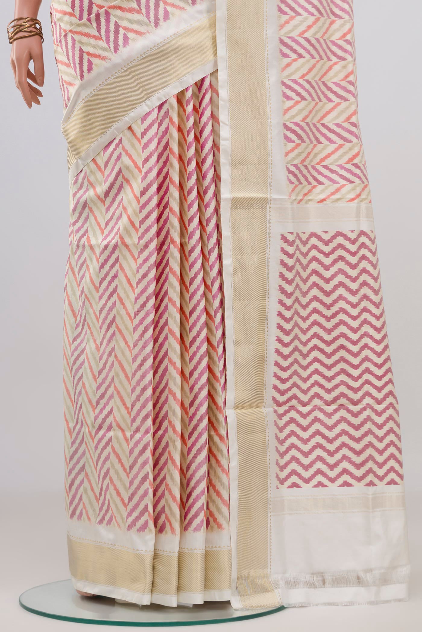 Pleats and pallu of Cream Pochampally Silk Saree with Ikat design on the body and Zari Border. 