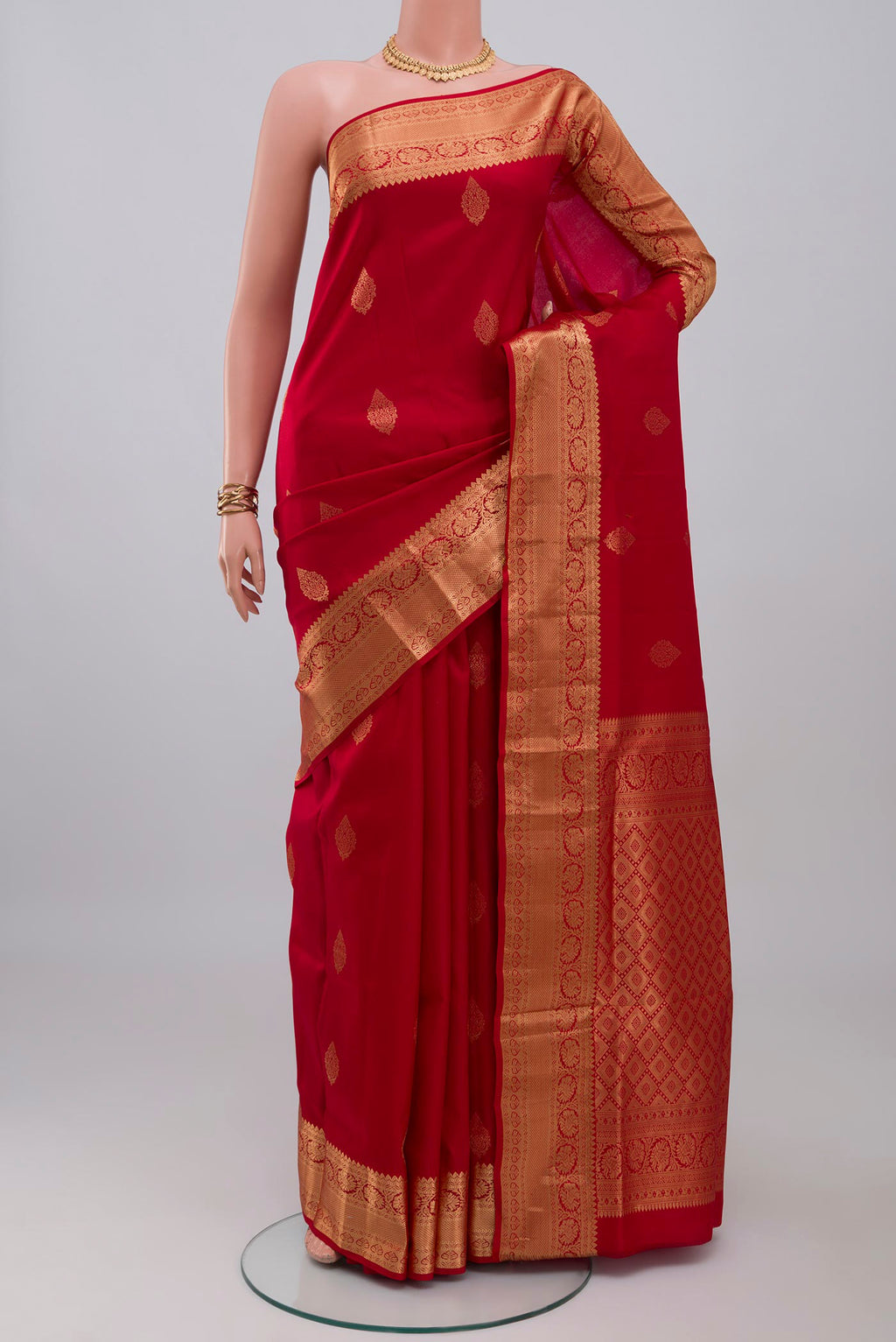 Red Soft Silk Saree with Zari Butta on the body and Zari Border.  displayed on a mannequin