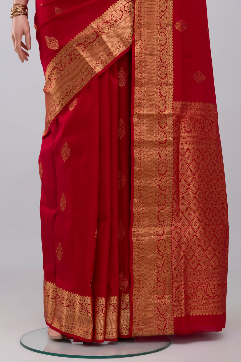 Pleats and pallu of Red Soft Silk Saree with Zari Butta on the body and Zari Border. 