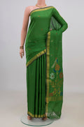Pure Silk Green Uppada Saree with Thread Butta on the body and Zari Border.  displayed on a mannequin